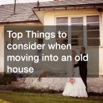 a couple next to an old house