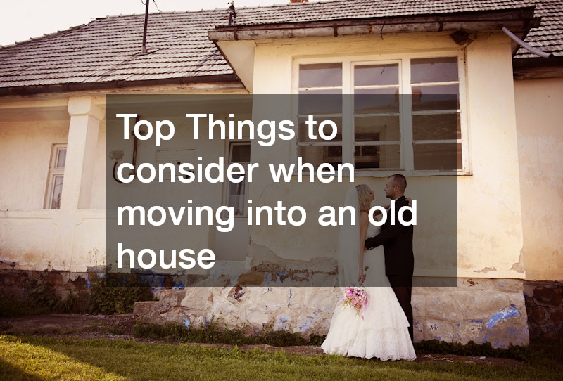 a couple next to an old house